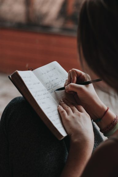 Own your narrative Woman writing in a book